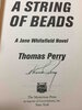 Another image of A STRING OF BEADS. by Perry, Thomas.